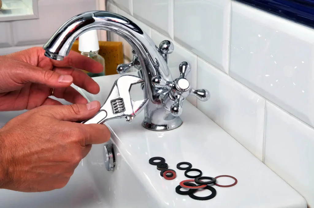 Plumber performing maintenance on a bathroom faucet in Loma Linda