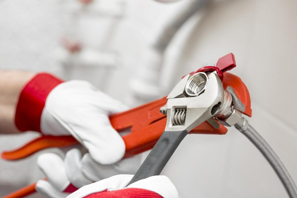 Plumber holding pipe wrenches for an emergency repair in Loma Linda