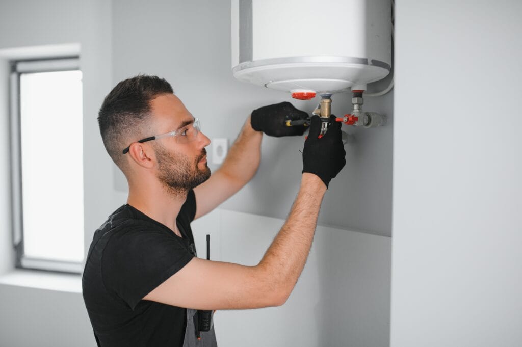 Technician performing water heater maintenance in Loma Linda